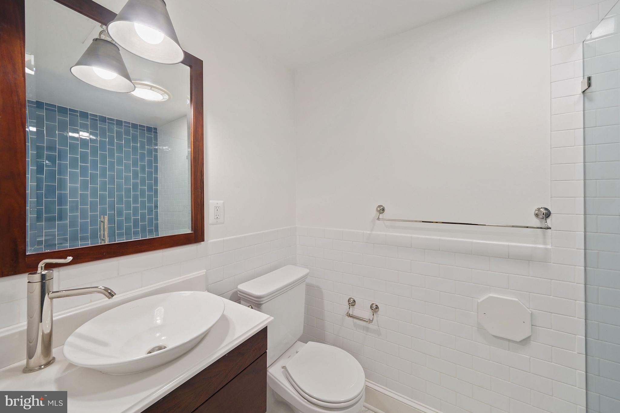 1226 Aldebaran Drive McLean, VA 22101 - Photo 31 of 40 a bathroom with a sink a toilet and mirror