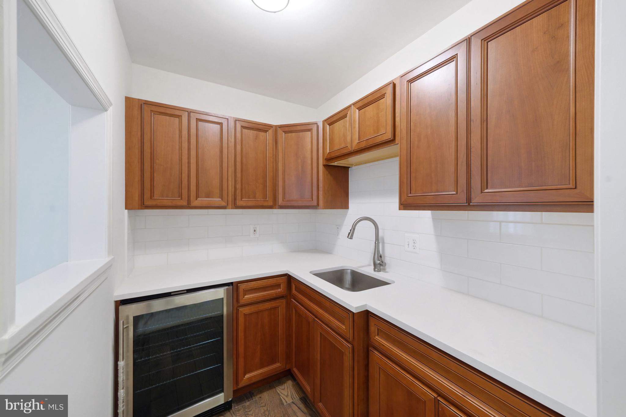 1226 Aldebaran Drive McLean, VA 22101 - Photo 34 of 40 a kitchen with stainless steel appliances granite countertop white cabinets a sink and dishwasher