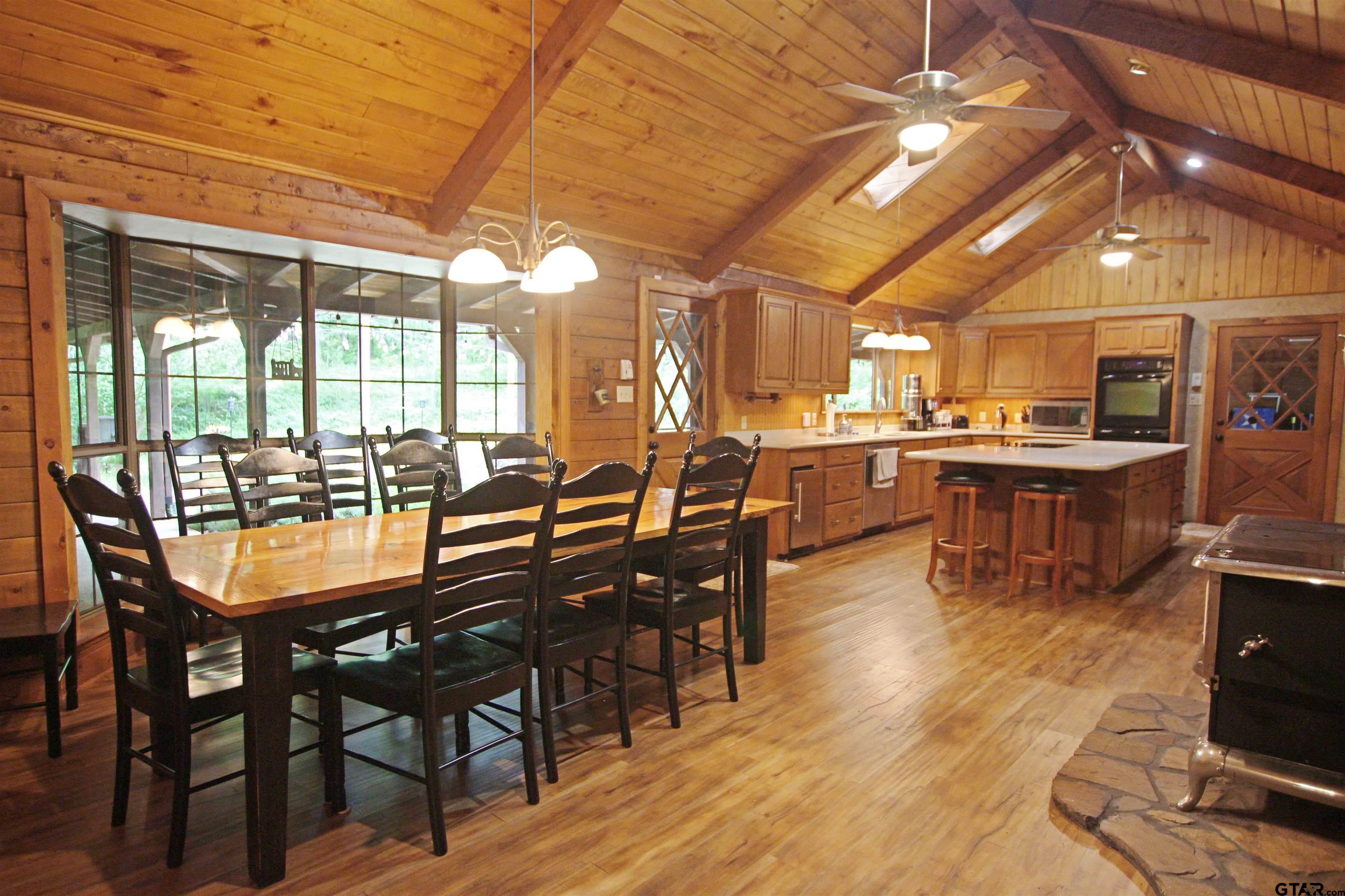 782 Rosie Wady Road Gladewater, TX 75647 - Photo 7 of 48 a dining hall with stainless steel appliances granite countertop a stove a sink a dining table and chairs with wooden floor