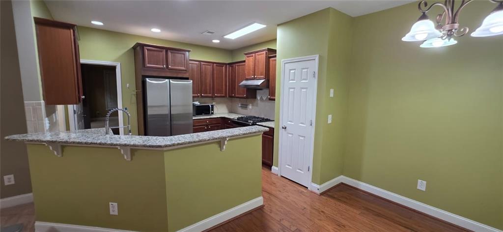 505 Wicklowe Place Acworth, GA 30102 - Photo 15 of 51 a kitchen with kitchen island a sink stainless steel appliances and cabinets