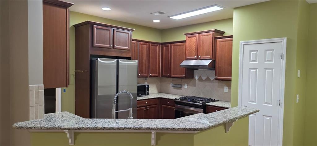 505 Wicklowe Place Acworth, GA 30102 - Photo 10 of 51 a kitchen with granite countertop stainless steel appliances granite countertop a sink a stove and a refrigerator