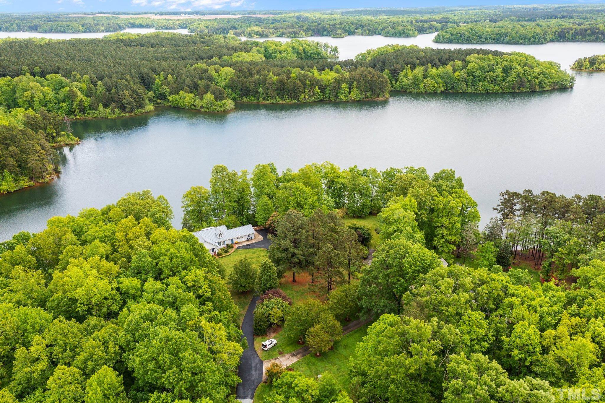 268 Dean Lane Roxboro, NC 27574 - Photo 15 of 38 a view of a lake with a houses in the back yard