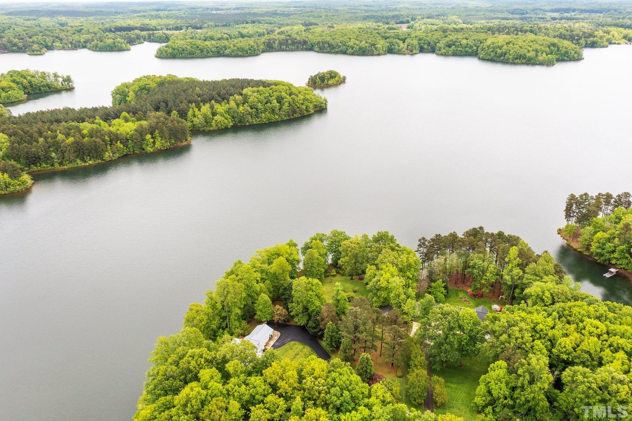 268 Dean Lane Roxboro, NC 27574 - Photo 17 of 38 a view of a lake with houses in the back