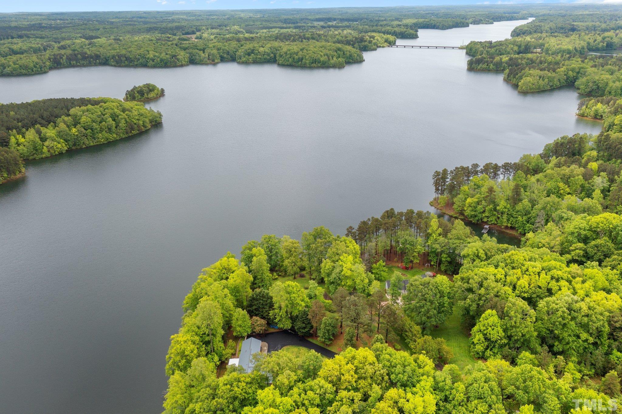 268 Dean Lane Roxboro, NC 27574 - Photo 18 of 38 a view of a lake with a house in the background