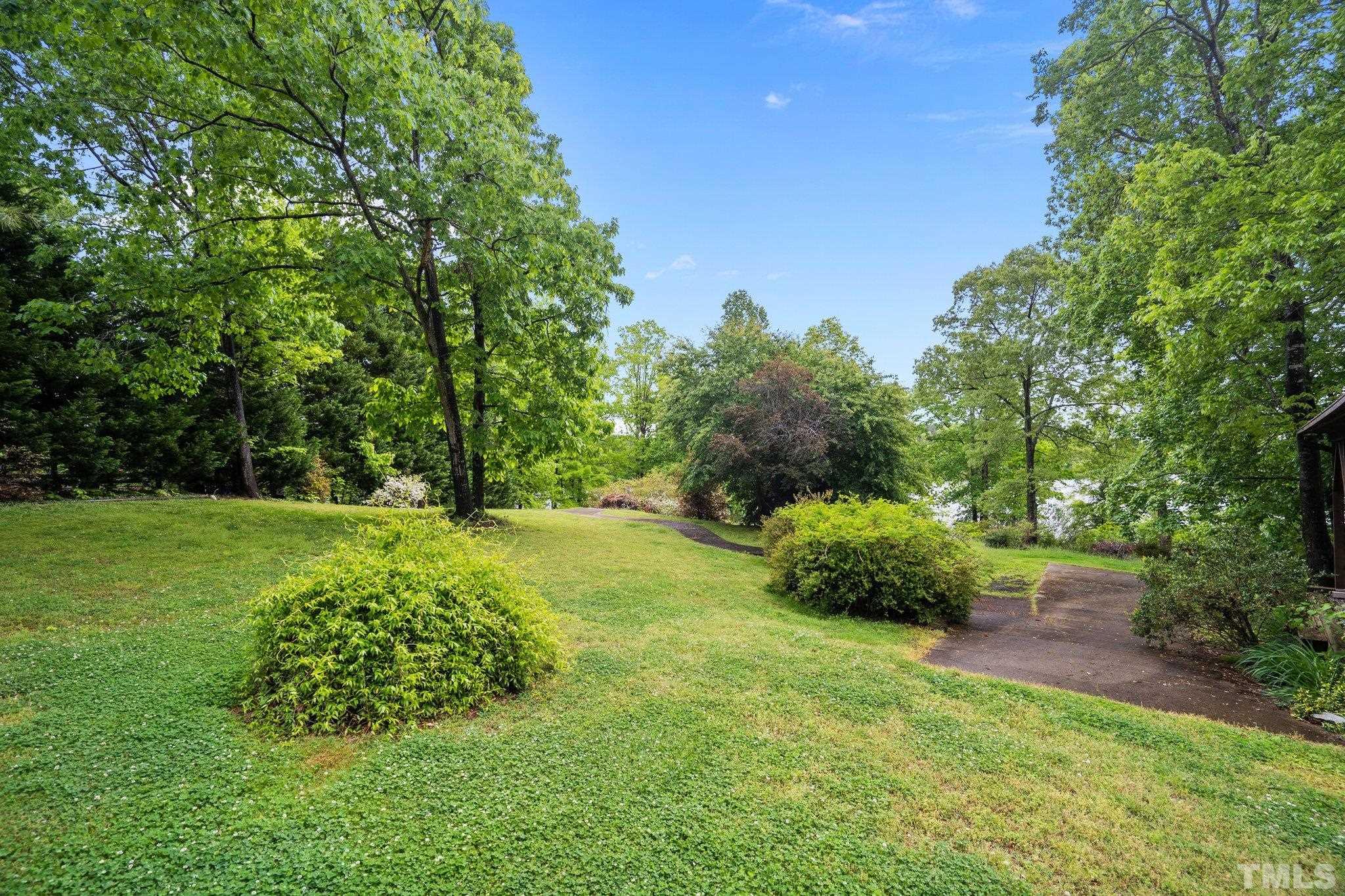 268 Dean Lane Roxboro, NC 27574 - Photo 6 of 38 a garden with trees in the background