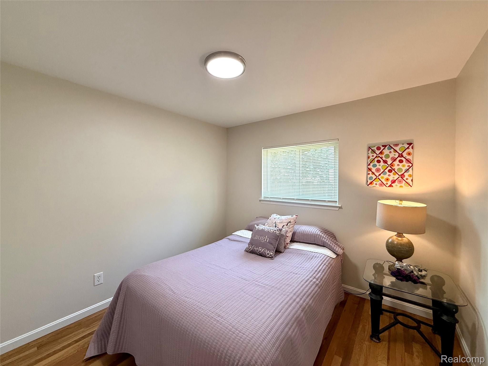 39909 Lynn Street Canton, MI 48187 - Photo 22 of 45 Bedroom featuring wood-finish flooring, neutral wall tones, and a single window with blinds