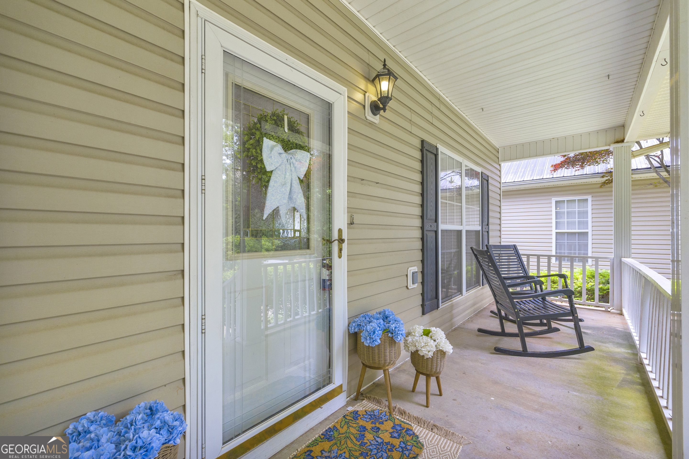 163 Tuxedo Drive Commerce, GA 30530 - Photo 11 of 62 a balcony with chairs and a potted plant