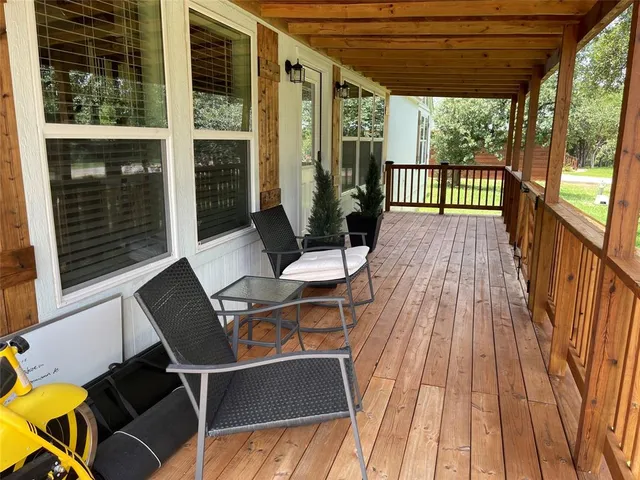 a view of balcony with wooden floor