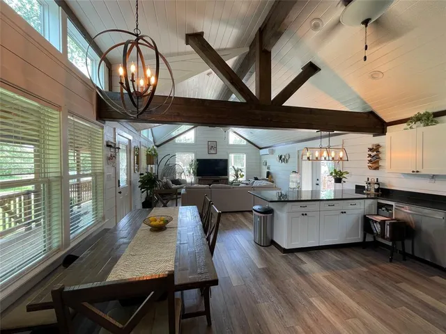 a kitchen with furniture wooden floor and stainless steel appliances