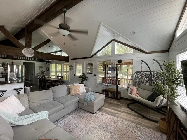 a living room with patio furniture and a large window