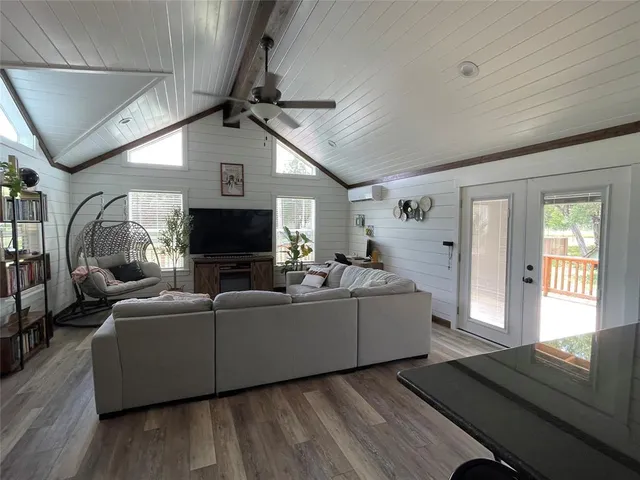a living room with furniture a flat screen tv and a fireplace