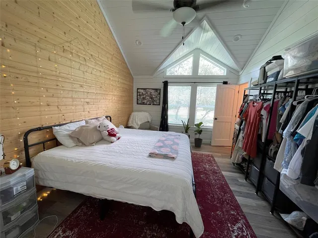 a bedroom with a large bed and a large window