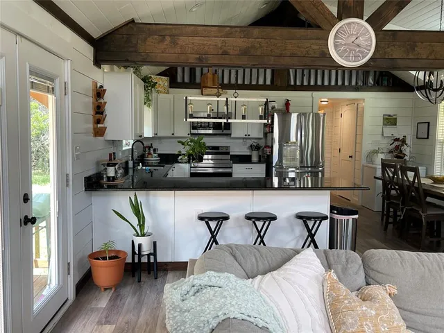 a living room with furniture a chandelier and a large window