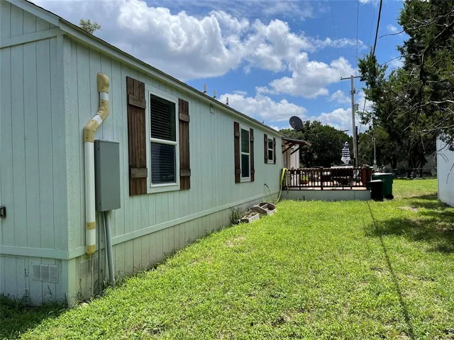 a view of a house with backyard and sitting area