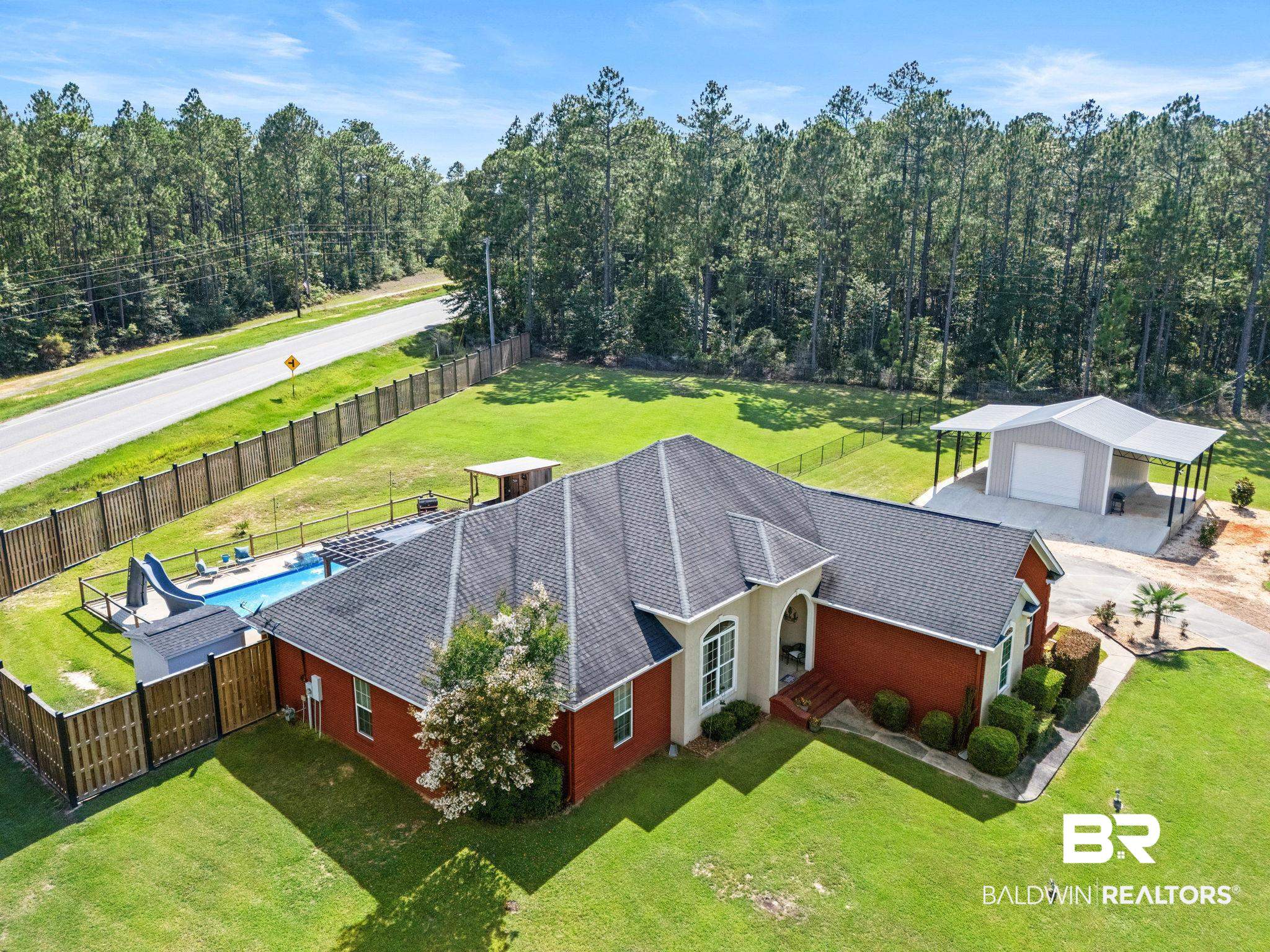 79 Whitetail Run Chatom, AL 36518 - Photo 9 of 82 Red brick residence with a gabled roofline and an arched entryway