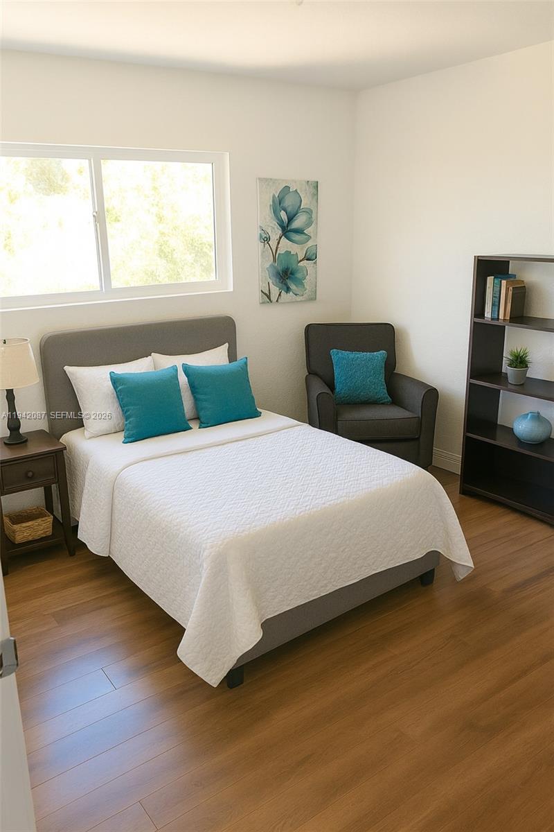 16585 Northeast 3rd Avenue Miami, FL 33162 - Photo 8 of 9 a bedroom with a bed and a couch