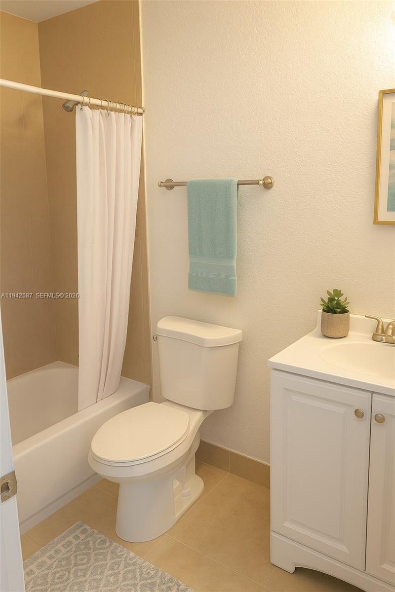 16585 Northeast 3rd Avenue Miami, FL 33162 - Photo 9 of 9 a white toilet sitting next to a bath tub