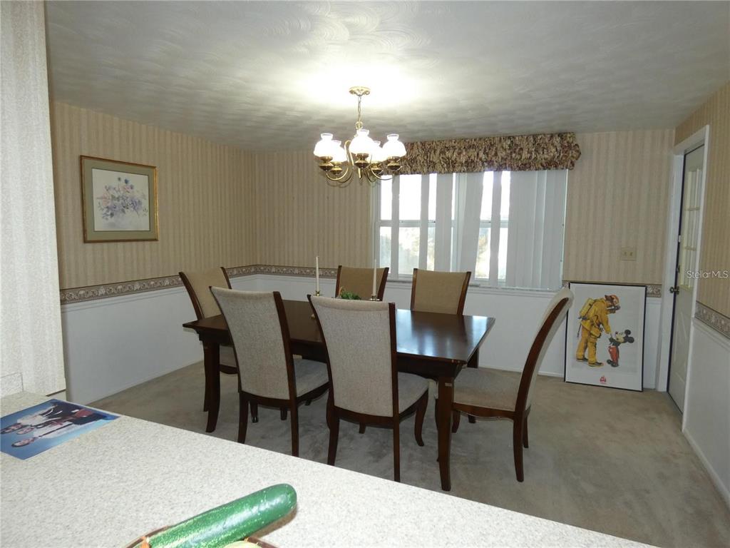 4392 Craftsbury Drive New Port Richey, FL 34652 - Photo 15 of 41 a view of a dining room with furniture and window