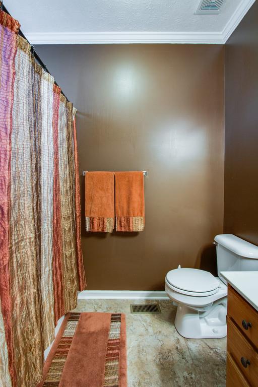 86 Big Springs Road Lebanon, TN 37087 - Photo 19 of 27 a bathroom with a toilet and a shower curtain