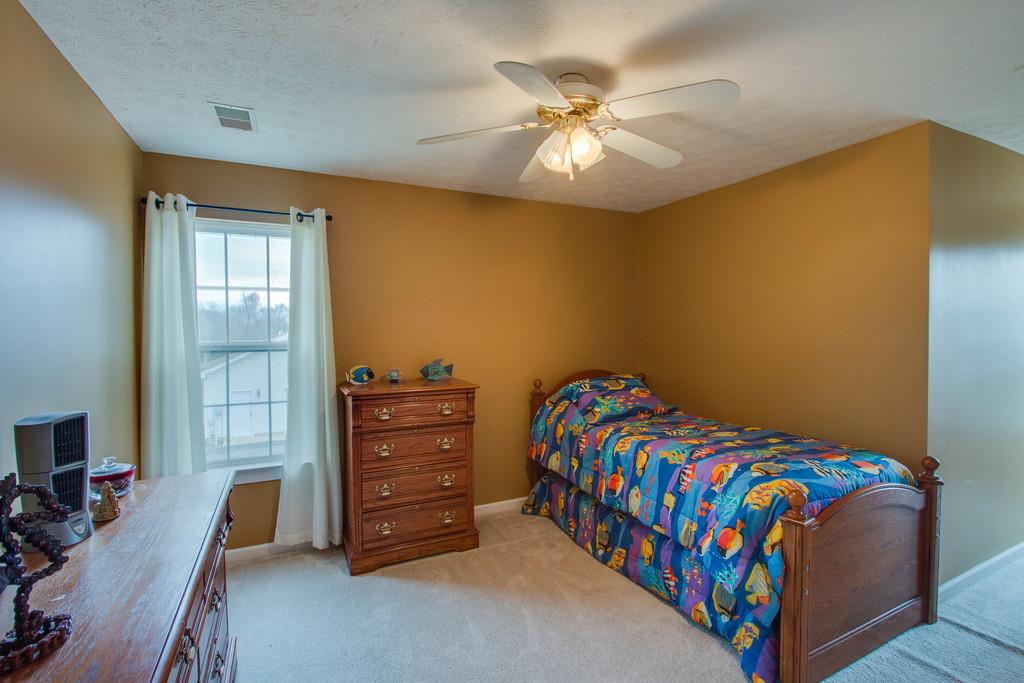 86 Big Springs Road Lebanon, TN 37087 - Photo 22 of 27 a bedroom with a bed and a chandelier