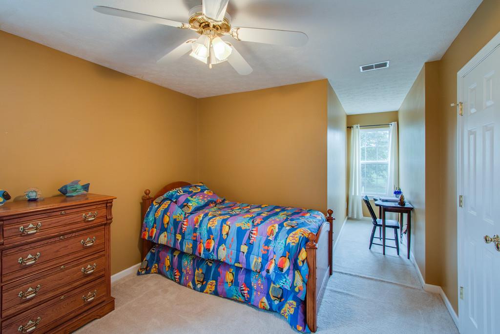 86 Big Springs Road Lebanon, TN 37087 - Photo 23 of 27 a bedroom with a bed and a chandelier