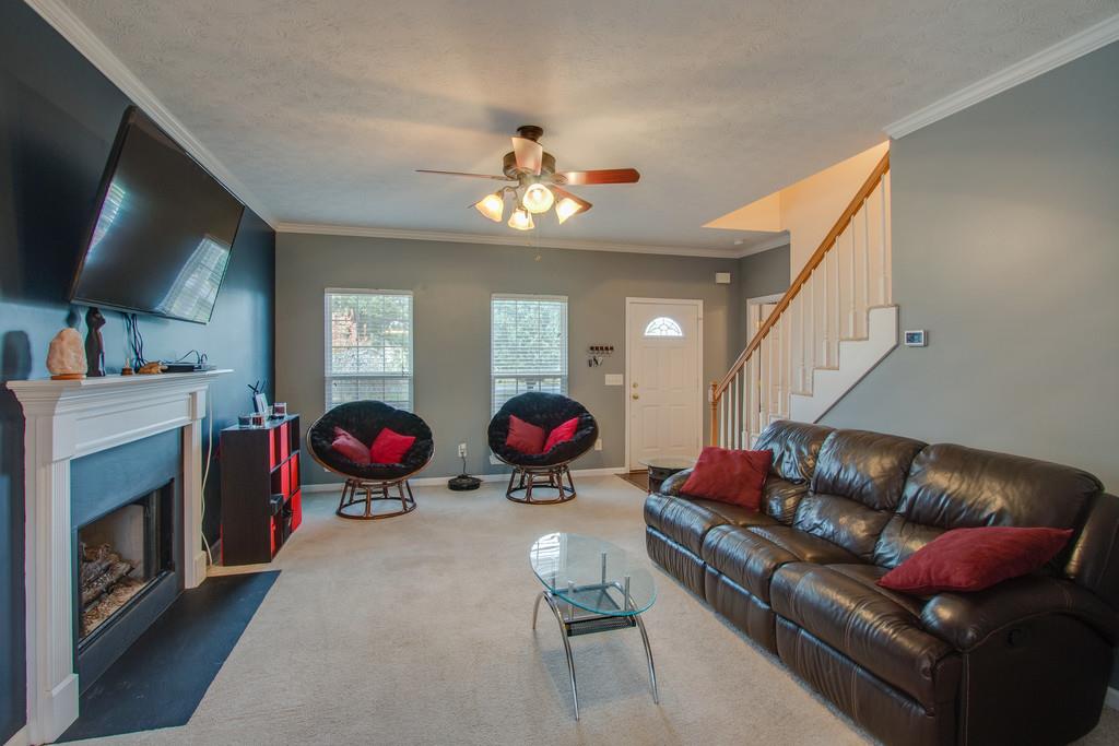86 Big Springs Road Lebanon, TN 37087 - Photo 7 of 27 a living room with furniture a flat screen tv and a fireplace
