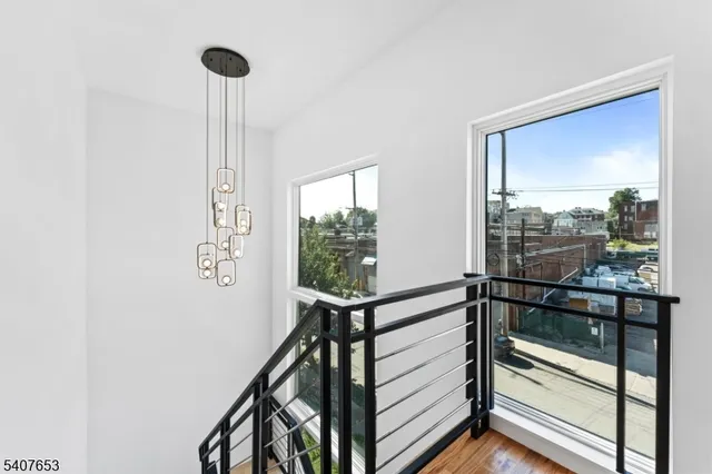 a view of a room with a window and wooden floor