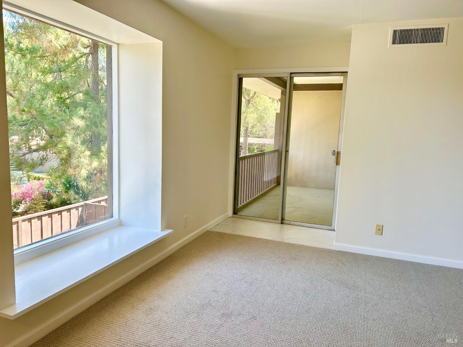9 Forest Lane San Rafael, CA 94903 - Photo 4 of 11 an empty room with sliding glass door and windows