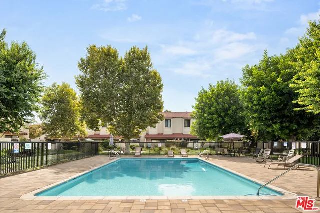 a view of swimming pool with chairs