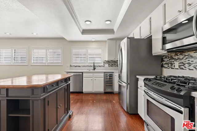 a kitchen with stainless steel appliances a stove a sink and a refrigerator