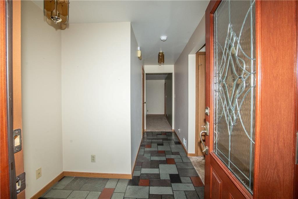 481 South Eberhart Road Butler, PA 16001 - Photo 5 of 25 a view of a hallway with wooden floor and a bathroom