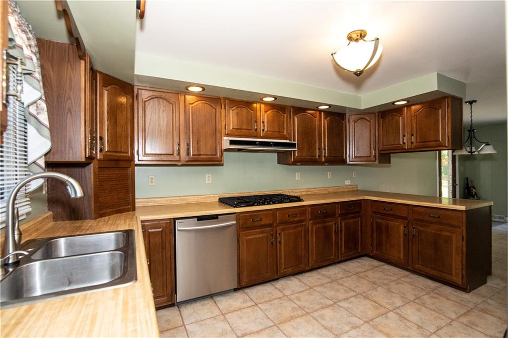 481 South Eberhart Road Butler, PA 16001 - Photo 6 of 25 a kitchen with stainless steel appliances granite countertop a sink and a stove