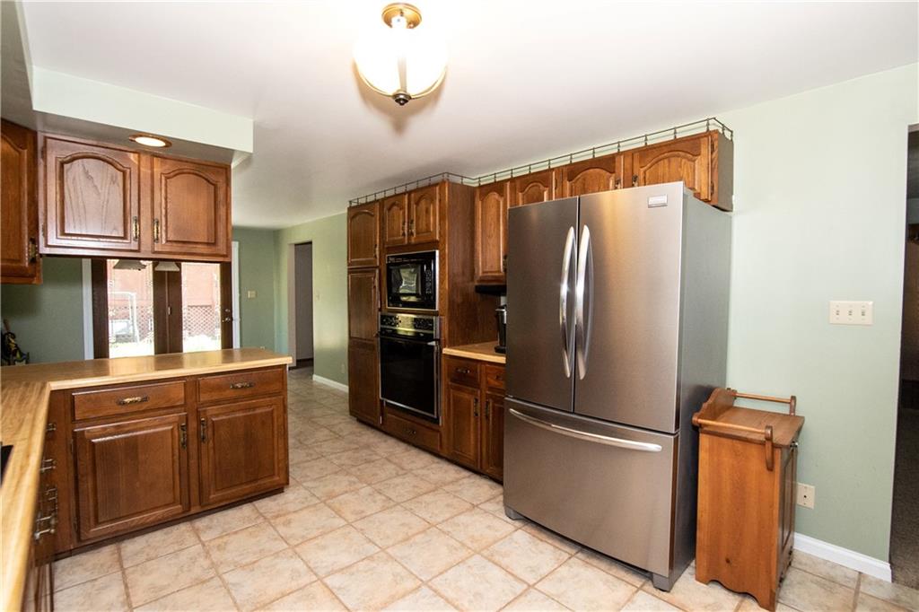 481 South Eberhart Road Butler, PA 16001 - Photo 7 of 25 a kitchen with stainless steel appliances granite countertop a refrigerator and a sink