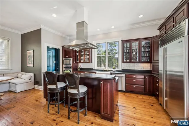a kitchen with granite countertop a sink cabinets and stainless steel appliances