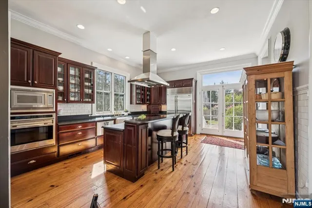a open kitchen with stainless steel appliances granite countertop a stove and refrigerator