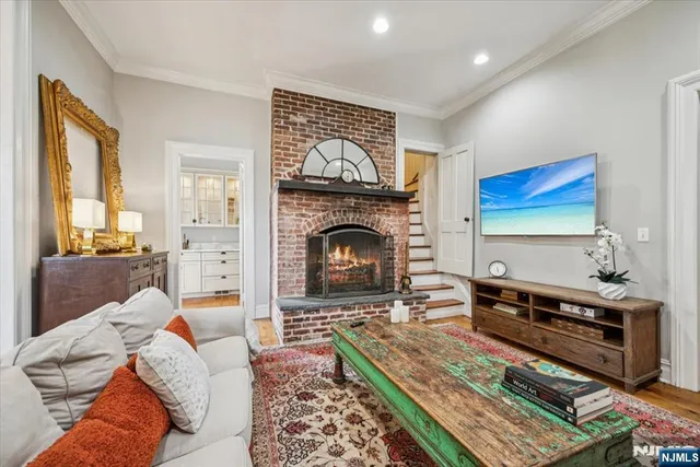 a living room with furniture a fireplace and a flat screen tv