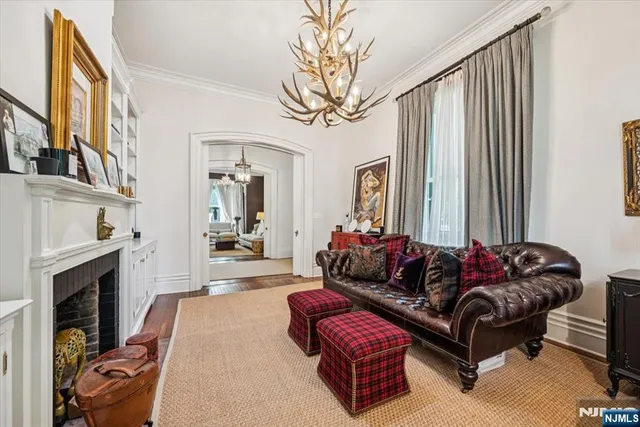 a living room with furniture a fireplace and a large window
