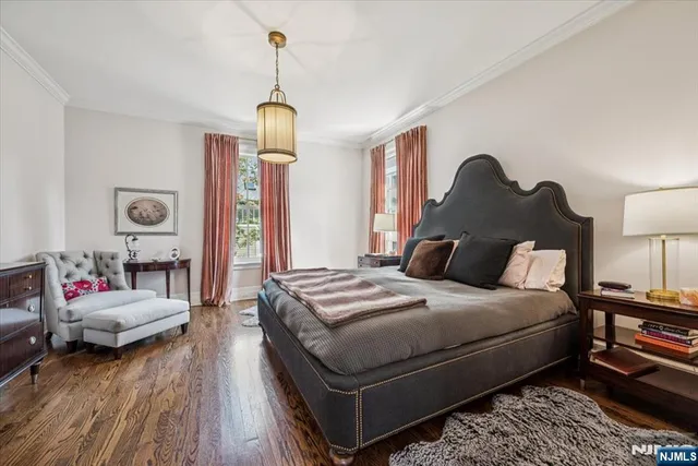a bedroom with bed and a chandelier