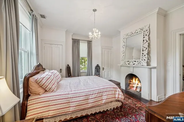 a bedroom with a bed and a chandelier