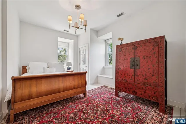 a view of hall way with furniture and chandelier