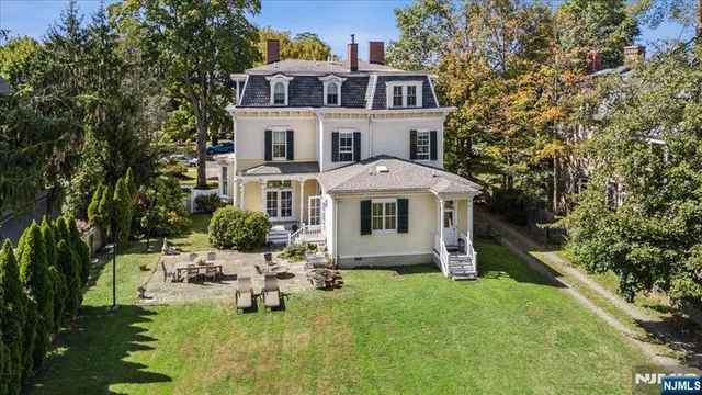a front view of a house with yard and green space