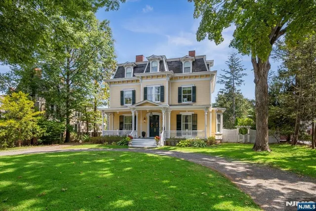 a front view of a house with a yard table and chairs