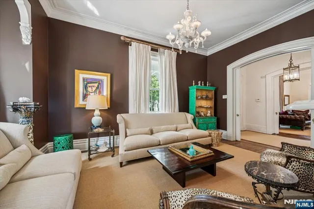 a living room with furniture and a chandelier