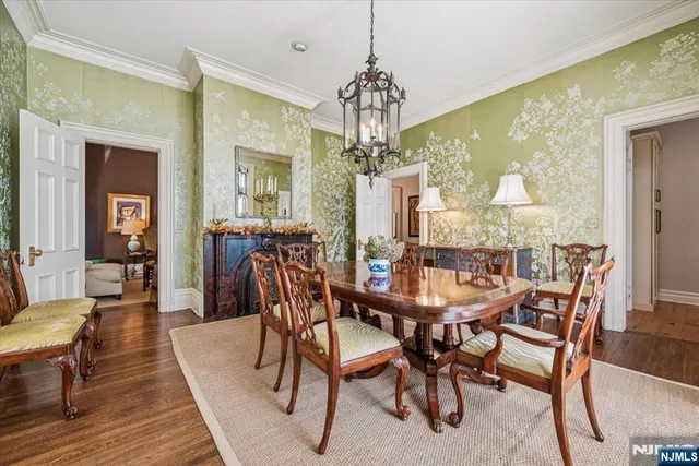 a dining room with furniture a chandelier and wooden floor