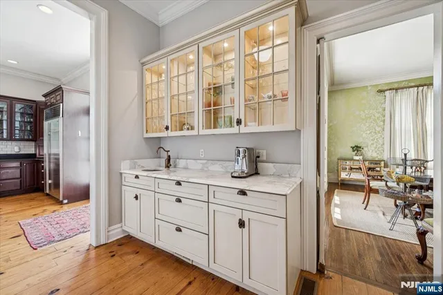 a spacious bedroom with a large bed a desk and chair with wooden floor