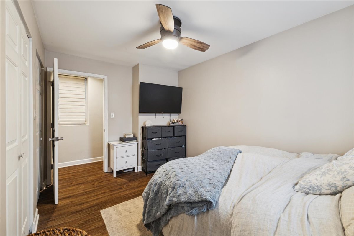 1111 North Honore Street, Unit 1 Chicago, IL 60622 - Photo 9 of 16 a bedroom with a bed and a flat screen tv