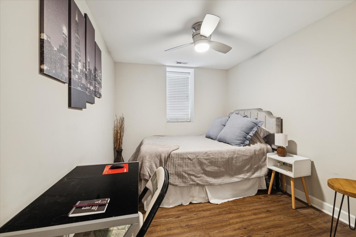 1111 North Honore Street, Unit 1 Chicago, IL 60622 - Photo 10 of 16 a bedroom with a bed and a chandelier