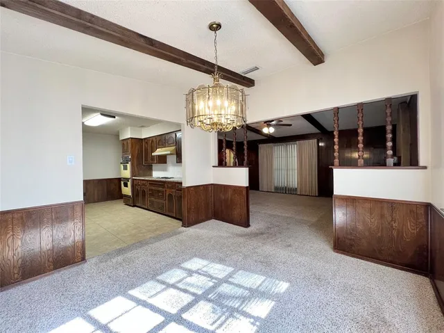 a large kitchen with stainless steel appliances granite countertop a sink and cabinets