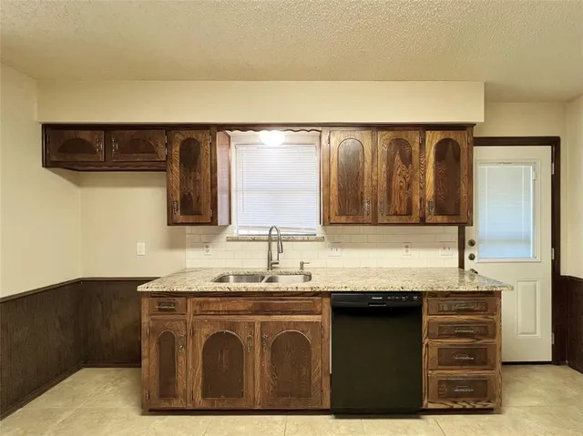 a kitchen with stainless steel appliances granite countertop a stove and a microwave