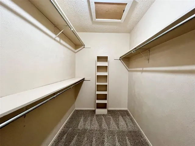 a bathroom with a granite countertop sink a mirror and a bathtub